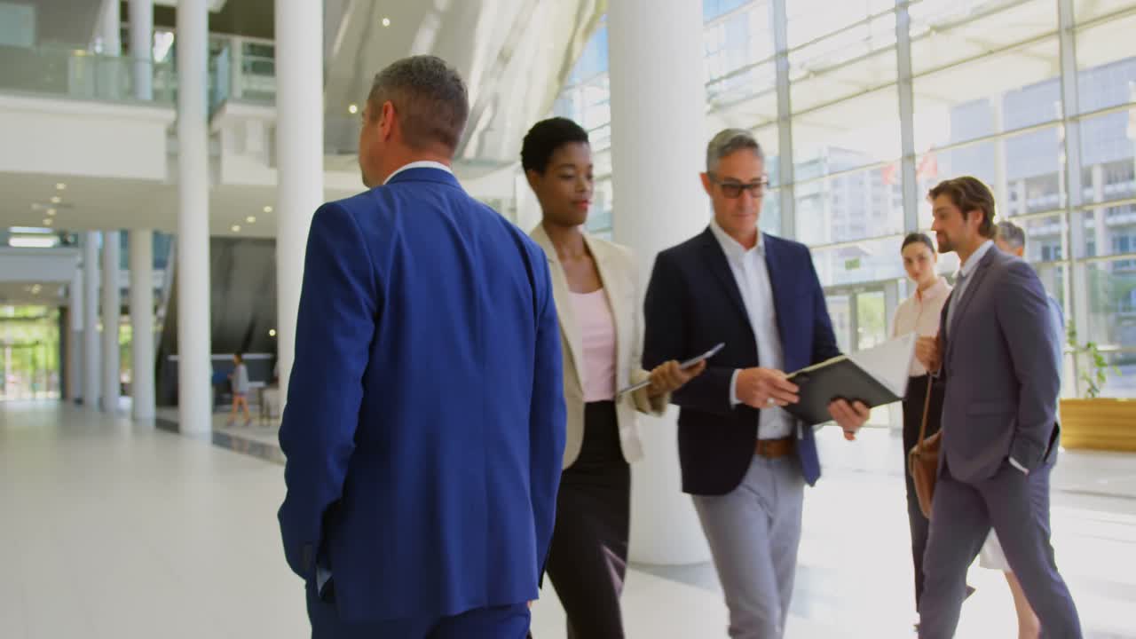 Caucasian businessman walking in the lobby at office 4k