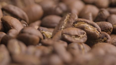 Super-close-up-of-roasted-brown-coffee-beans,-spinning-camera-shot