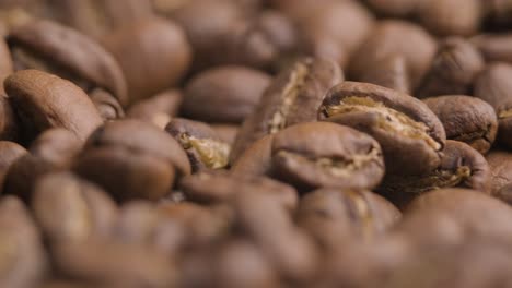 super close up of roasted brown coffee beans, spinning camera shot