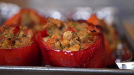 panning slowly along a row of freshly baked stuffed sweet bell peppers - temptingly appetizing