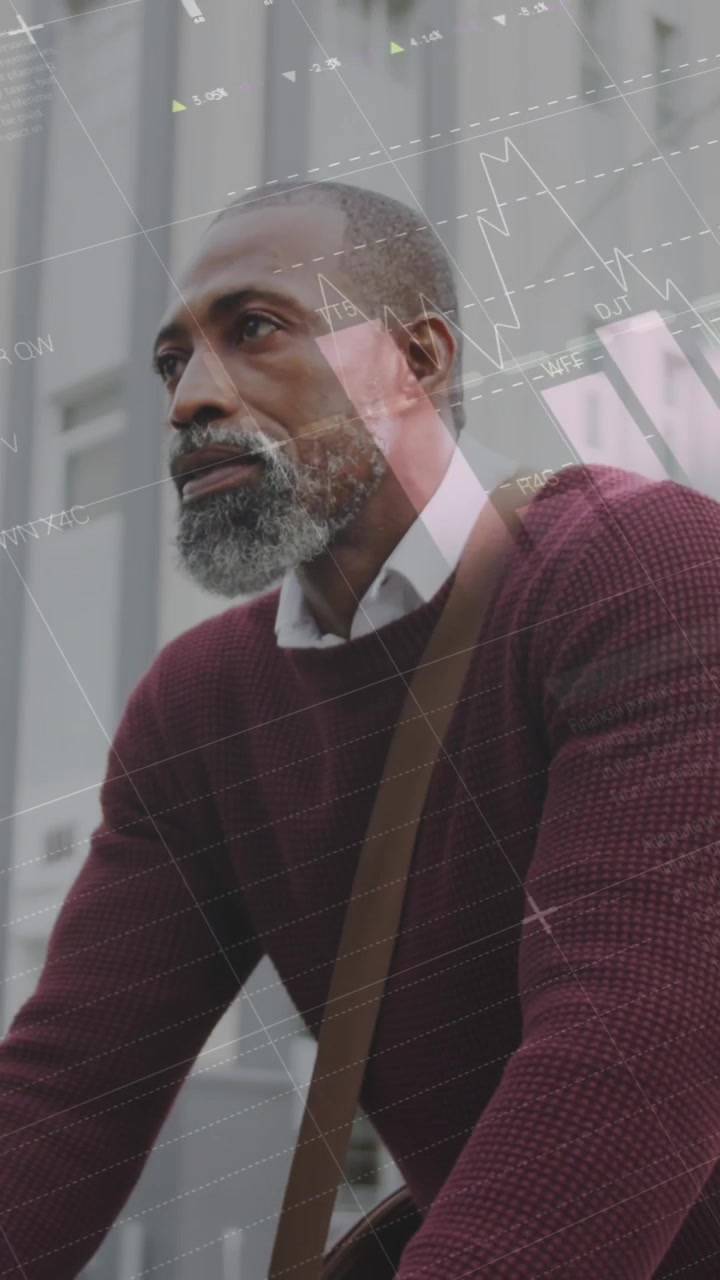 Animation of infographic interface over senior african american man riding bicycle on street in city