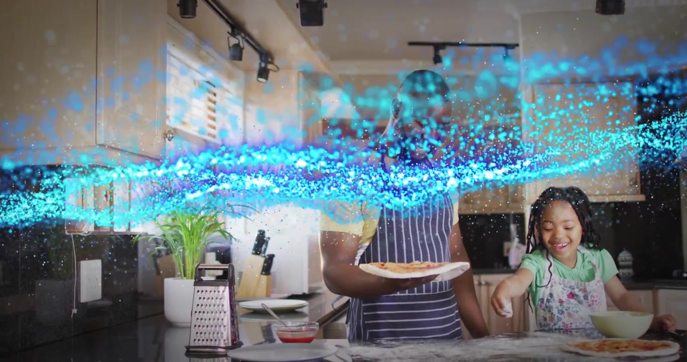 Father holding pizza base and activating blue wave, girl sprinkling toppings showing kitchen tech