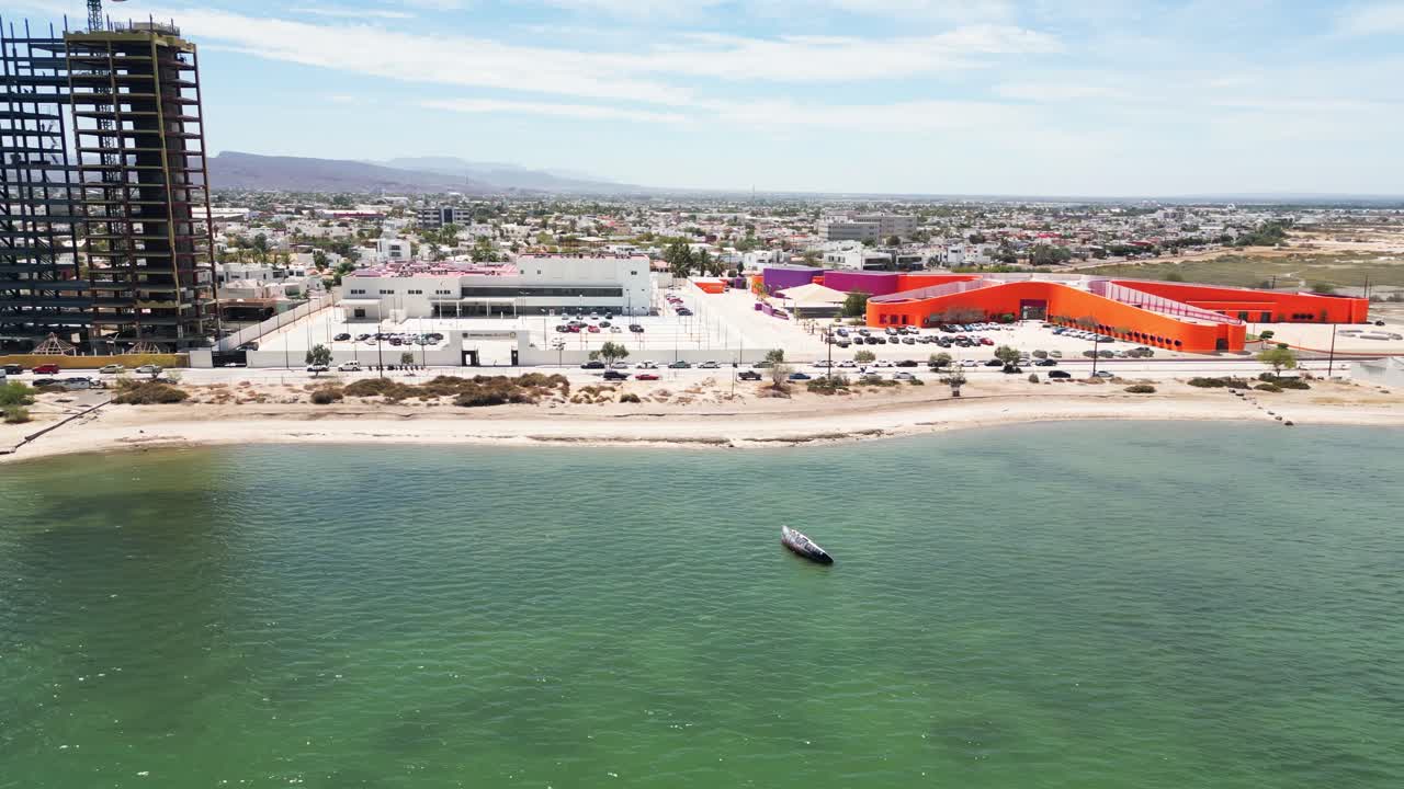 Beachfront cityscape in La Paz, Mexico with colorful buildings and calm sea view