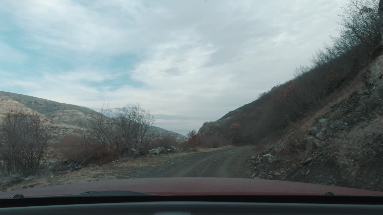 Adventure roadtrip on rocky road towards a remote village