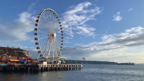 beautiful wide shot of the famous seattle tourist destination ferris wheel on pier 57 during golden hour on a warm sunny summer day in the state of washington in the united states of america