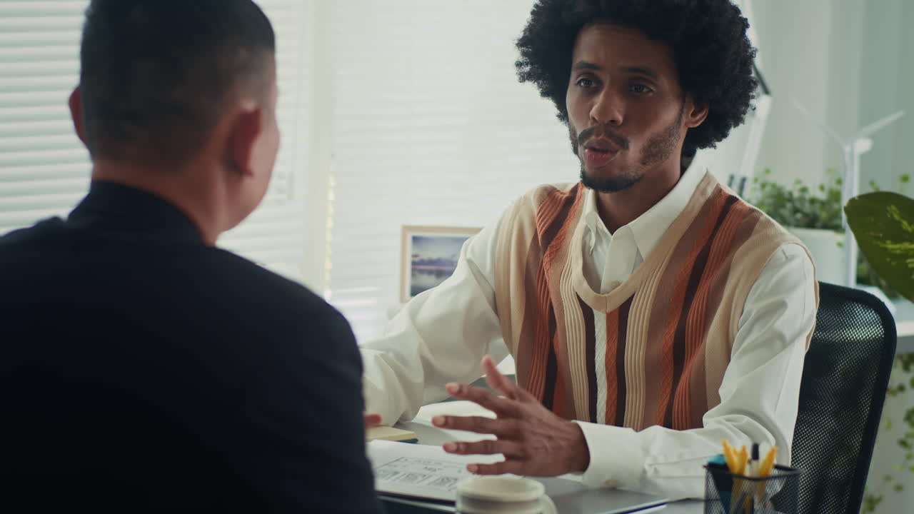 Two men having a discussion in an office