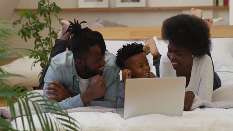 family using laptop together at home