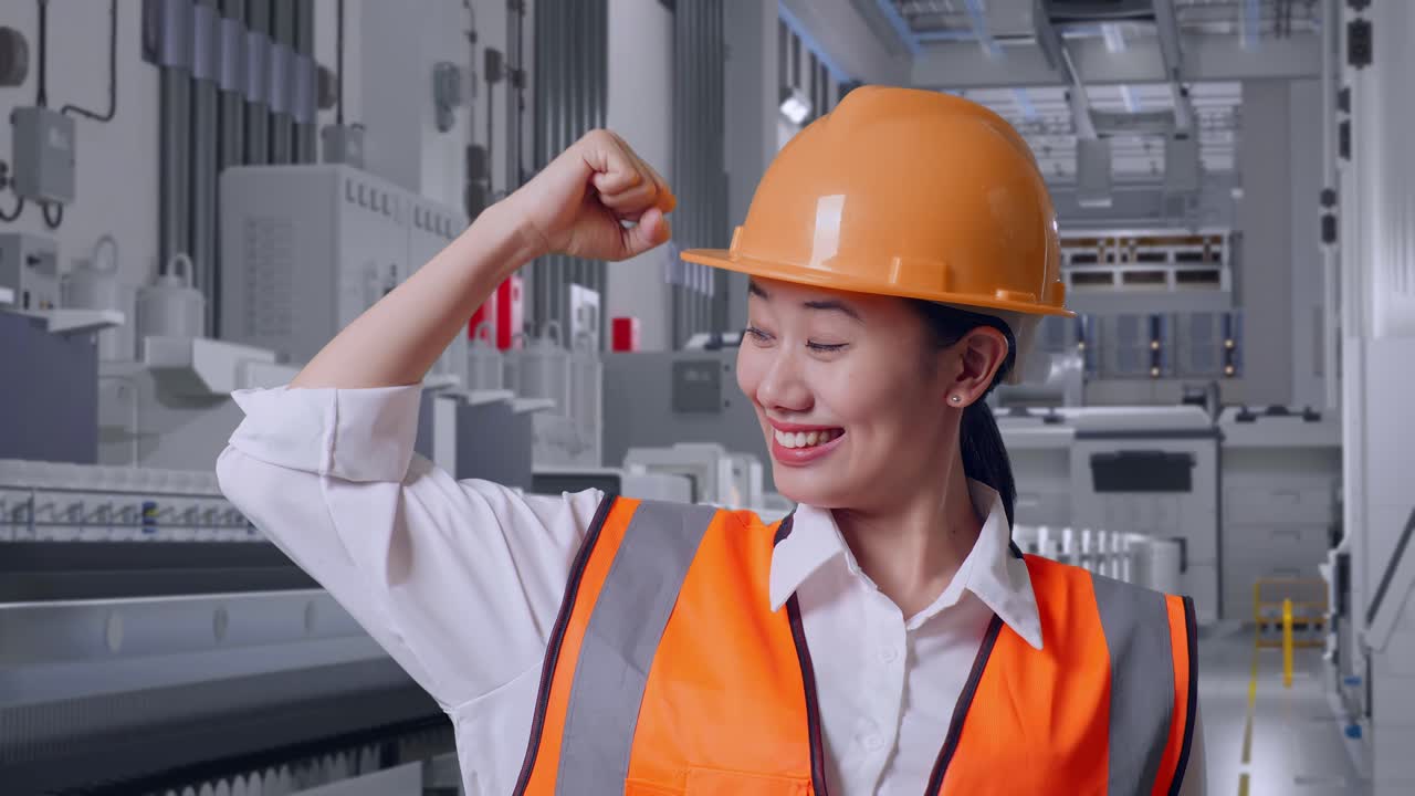 Close Up Of Asian Female Engineer With Safety Helmet Flexing Her Bicep And Smiling To Camera At Pharmaceutical Factory, Vaccine Production Facility