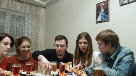 friends eating pizza and drinking beer