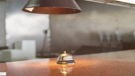 Restaurant-dinner-bell-on-a-counter-at-a-beach-side-bar