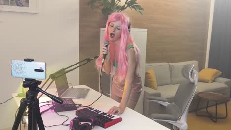 woman singing and playing music in home studio