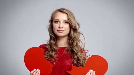 worried woman with broken heart in studio shot