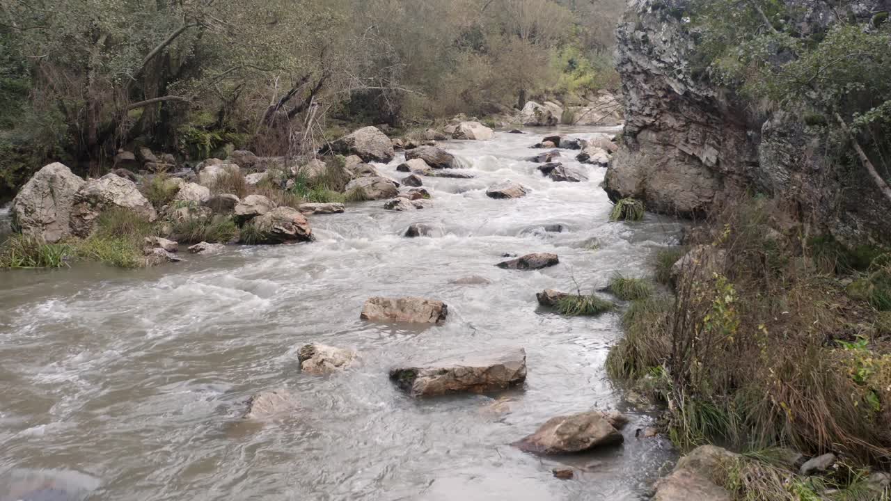 corriente de agua rodeada y estrellándose sobre rocas en un río pacífico durante el día cerca de oporto, portugal