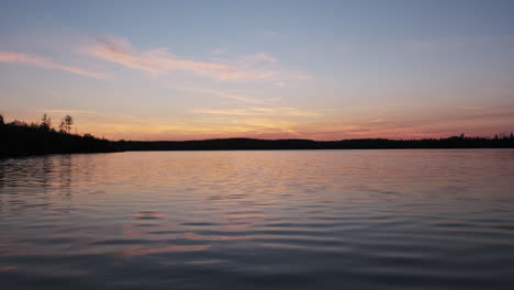 calm scenic sunset on a beautiful lake with water ripples