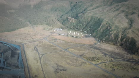 Aerial-thorsmörk-campside-tents-in-thor-valley-between-mossy-green-mountain-landscape