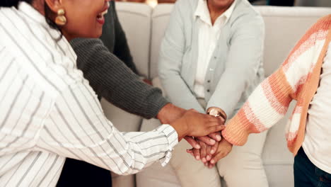 group of diverse women stacking hands in a show of support