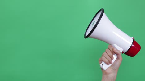 woman hand holding megaphone on green chroma key