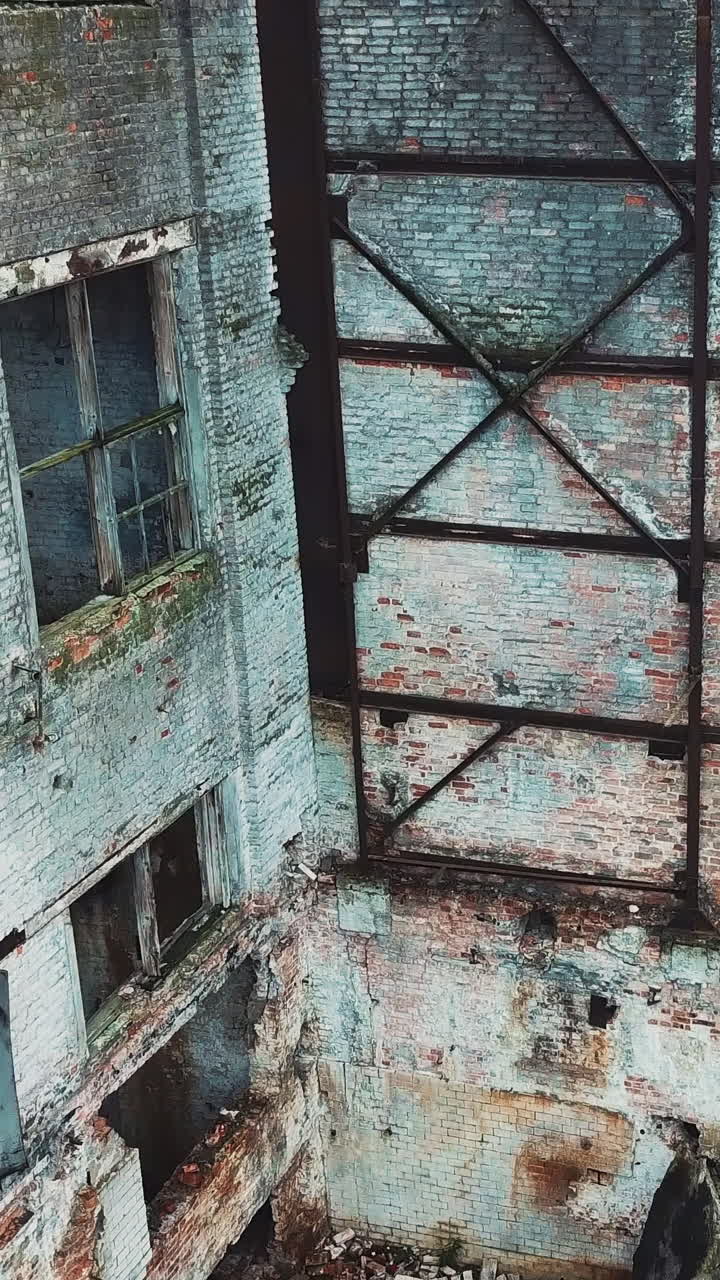 Flight over the destroyed factory. Old industrial building for demolition.. Vertical video