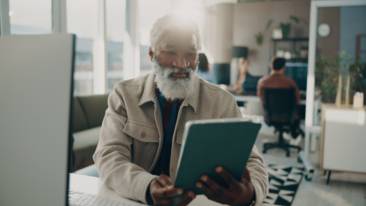 Senior Businessman Using Tablet in Office