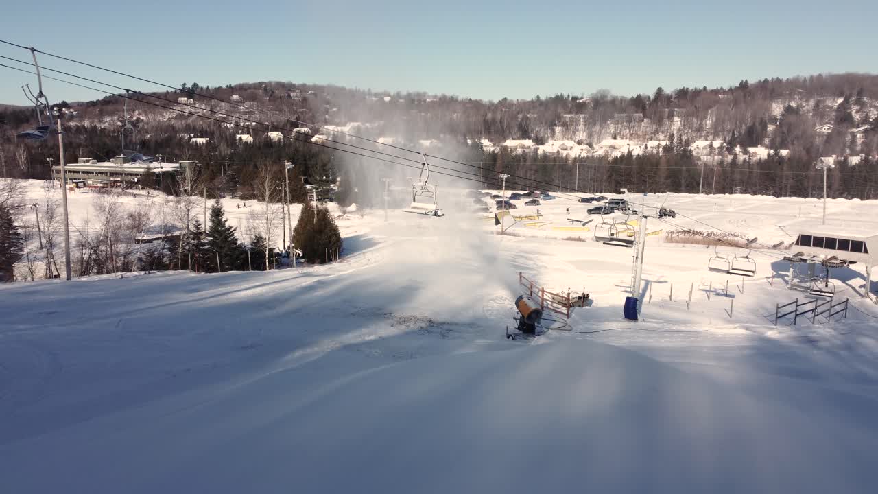Drone shot of ski lift on a snow resort in Saint-Sauveur, Quebec, Canada during winter on a snowy day