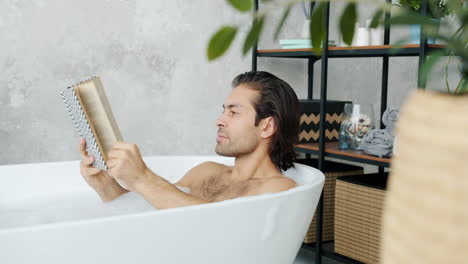 man reading in a bathtub