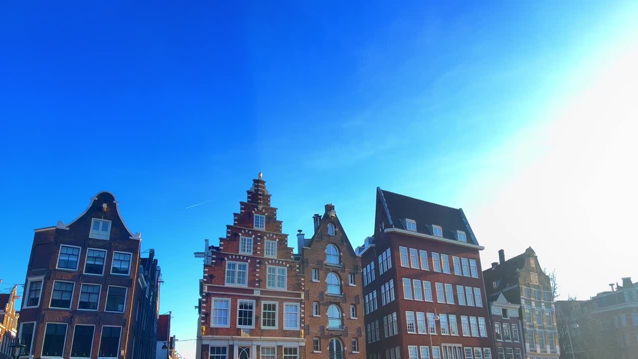 Typical Amsterdam canal houses roofs in historic city center at Geldersekade