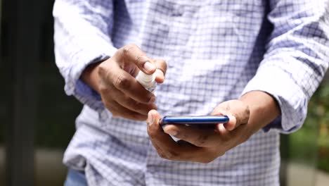 Man-hand-cleaning-mobile-phone-display