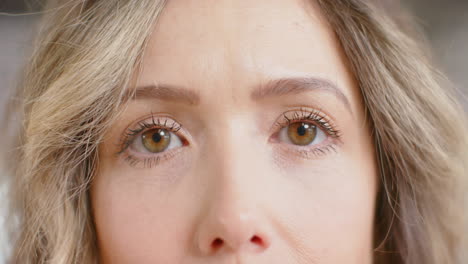 Portrait-of-happy-eyes-of-caucasian-casual-businesswoman-in-office,-slow-motion