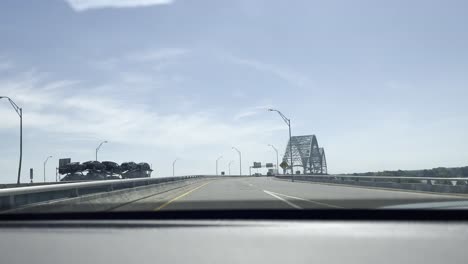 driving plate, view of a car approaching a bridge