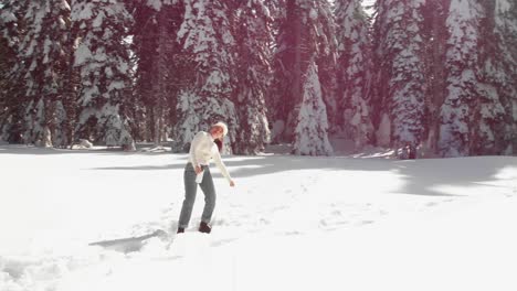 Girl-happy-dancing-in-snowy-mountain-area-in-sunny-day