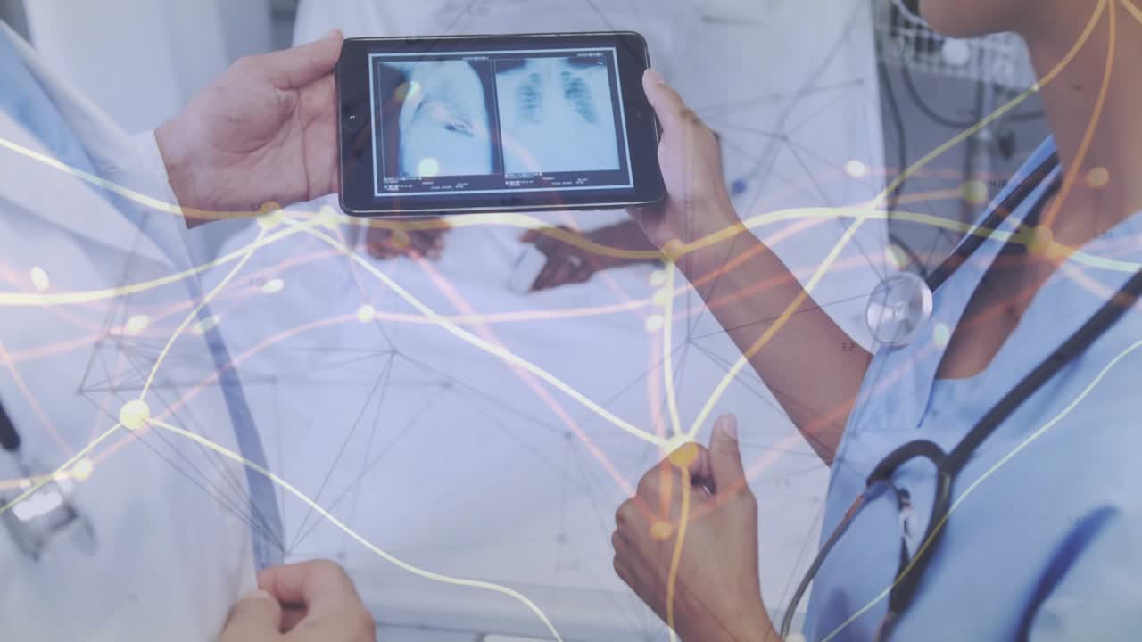 Female doc tapping tablet, doctor pointing Xray at bed, medical overlay showing lung for care