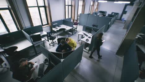 people working and collaborating in a modern open-plan office environment