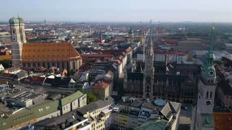 aerial establishing shot of munich's famous marienplatz square on summer morning