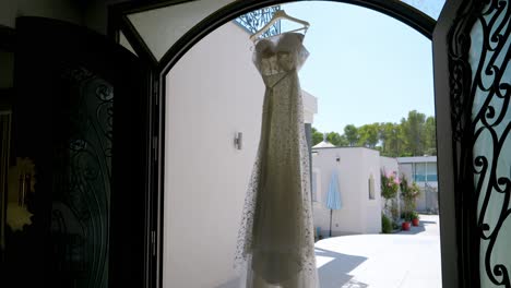 wedding dress hanging in ornate entryway