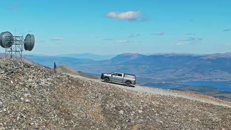 off-roading a truck on a mountain peak with stunning views