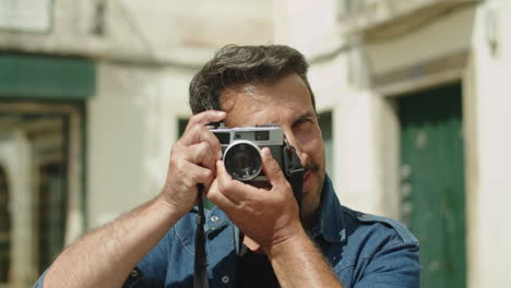 Front-view-of-handsome-Caucasian-man-with-camera