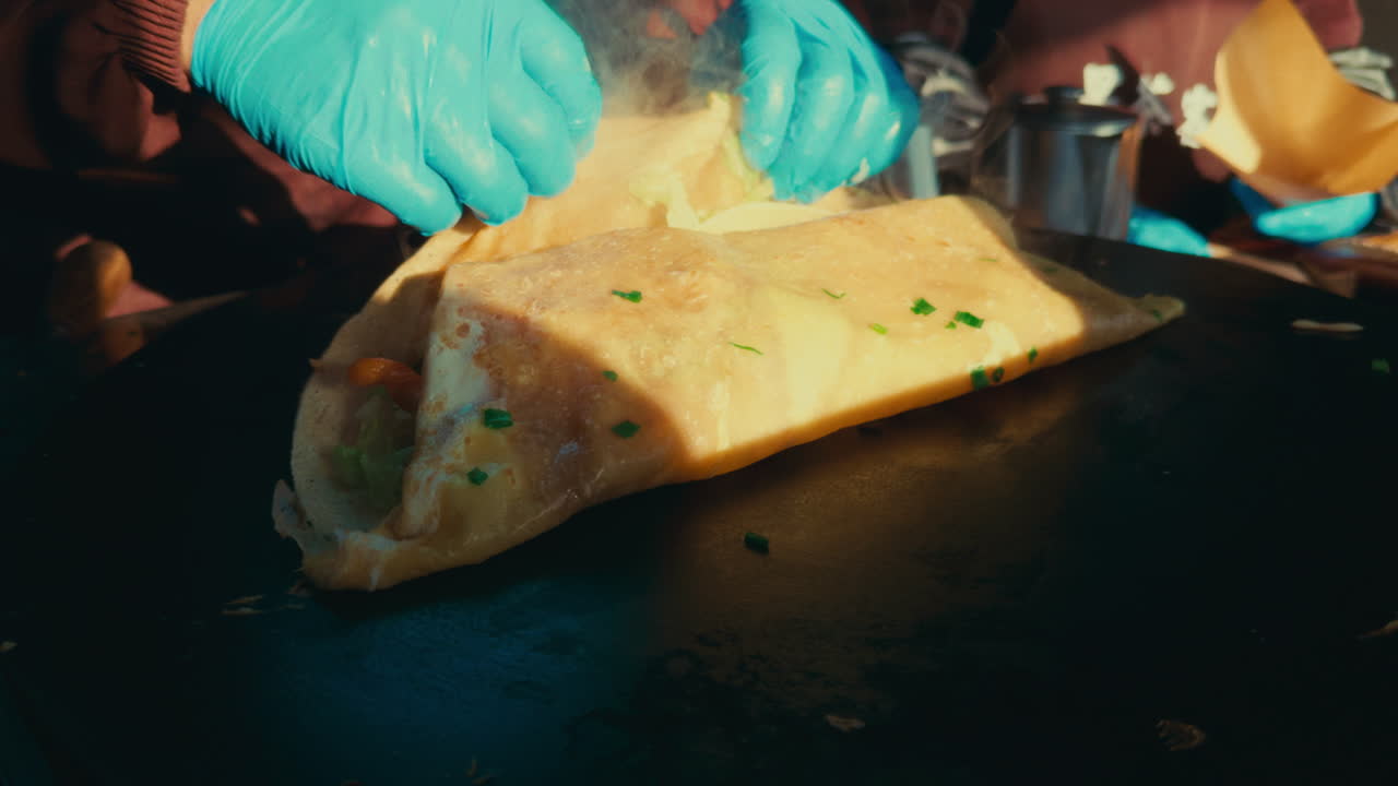 Grilled savory pancake topped with herbs being prepared in Wuzhen, China