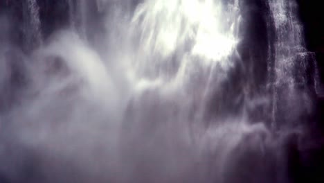 water, spray and mist pour down the side of a mountain in this powerful waterfall - close up isolated