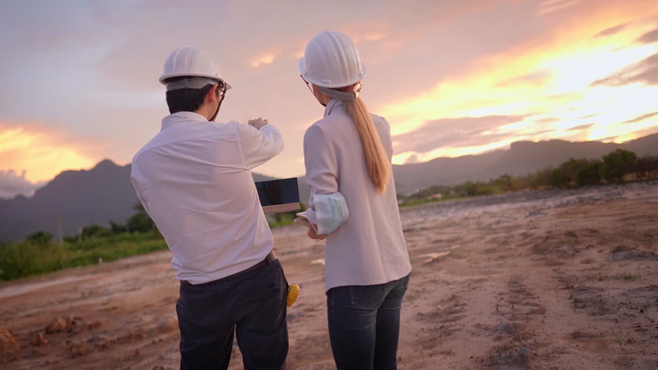 A professional constructor father giving a job explanation to young adult inherit daughter on his working place, inheriting a family business, real estate development, wearing safety equipment