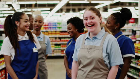 group of smiling supermarket employees