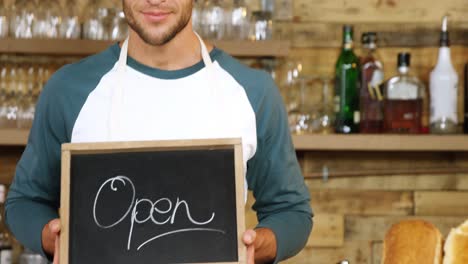 male waiter standing with open sign board 4k