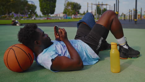 man resting with a basketball after a workout