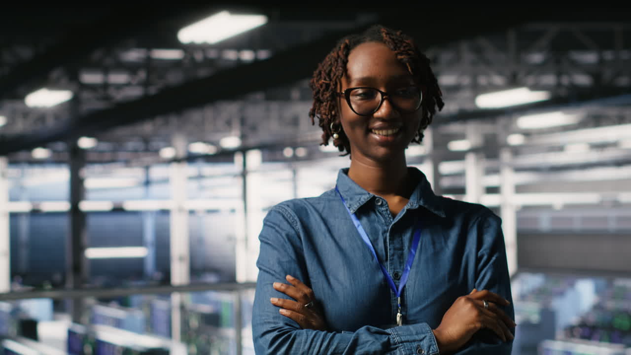 Portrait of smiling data center admin next to coworkers