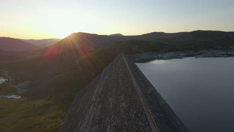drone view during golden hour of sysen embankment dam, hardanger plateau