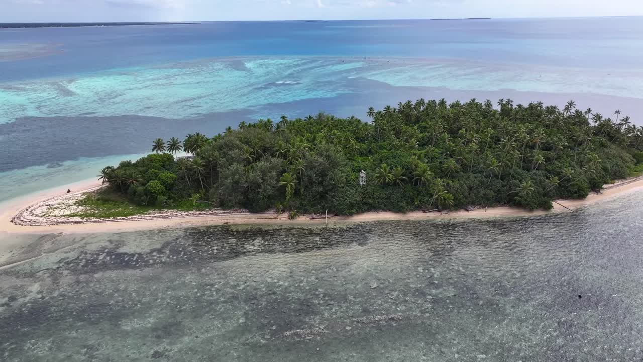 Remote exotic tropical island with palm trees and sandy beach in Tonga, South Pacific. Drone