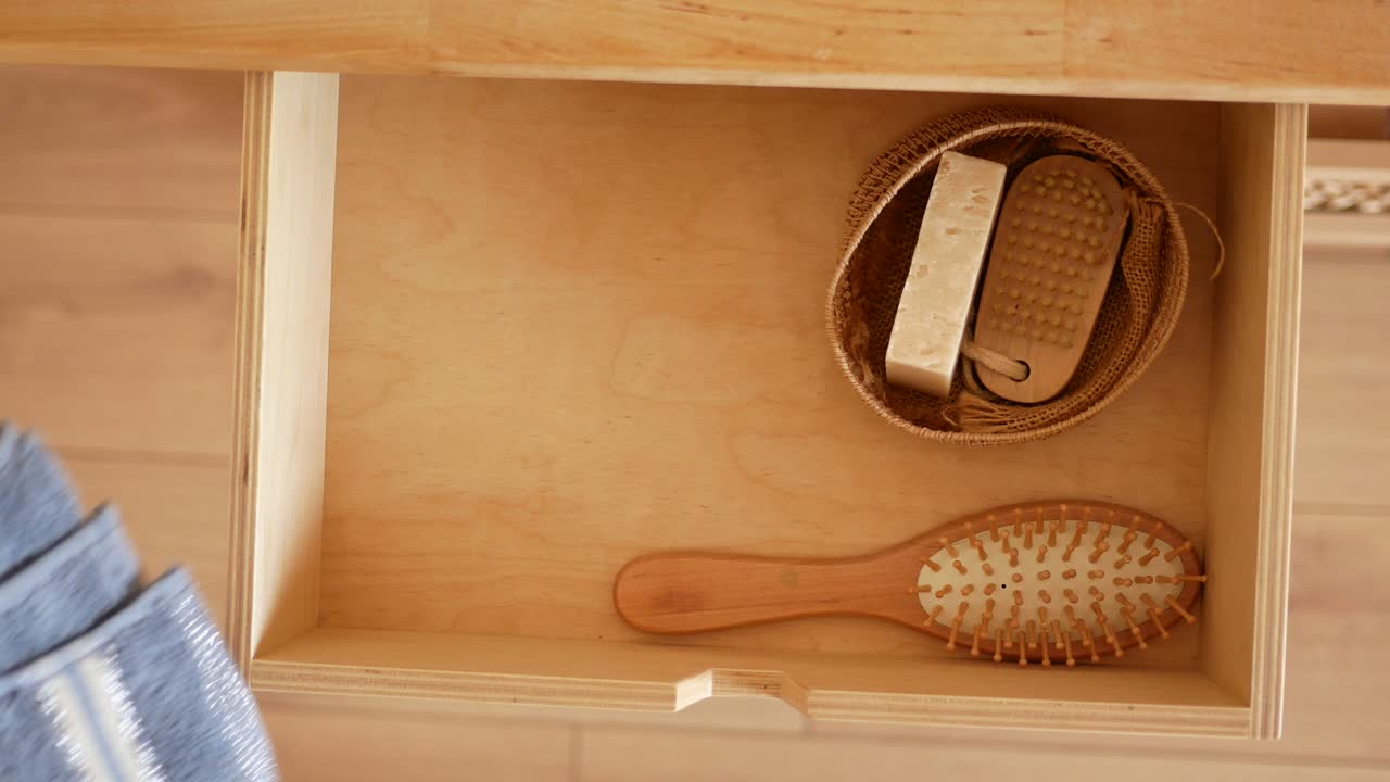 Bathroom drawer with towel, soap, and hairbrush