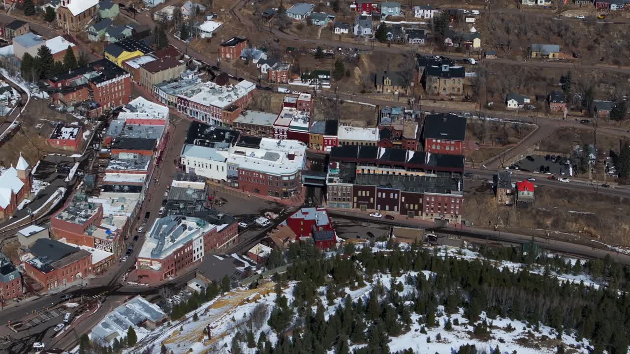 Downtown Central City Black Hawk Colorado Birds Eye view aerial drone view city historic buildings townhall winter sunny daytime bluesky Gold mining town streets casinos cars driving pan left motion
