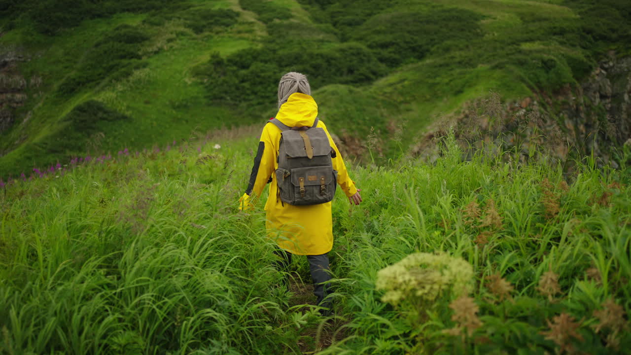 Woman Hiking in Lush Green Mountains