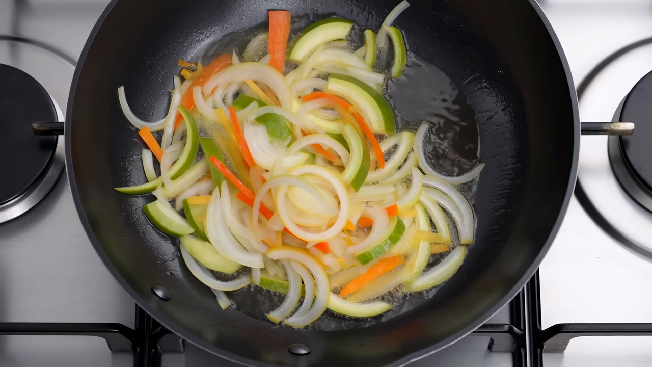 Sliced Onion Pepper Sizzling In Skillet, Vibrant Zucchini And Carrot Strips Tossed With Light Oil, Wooden
