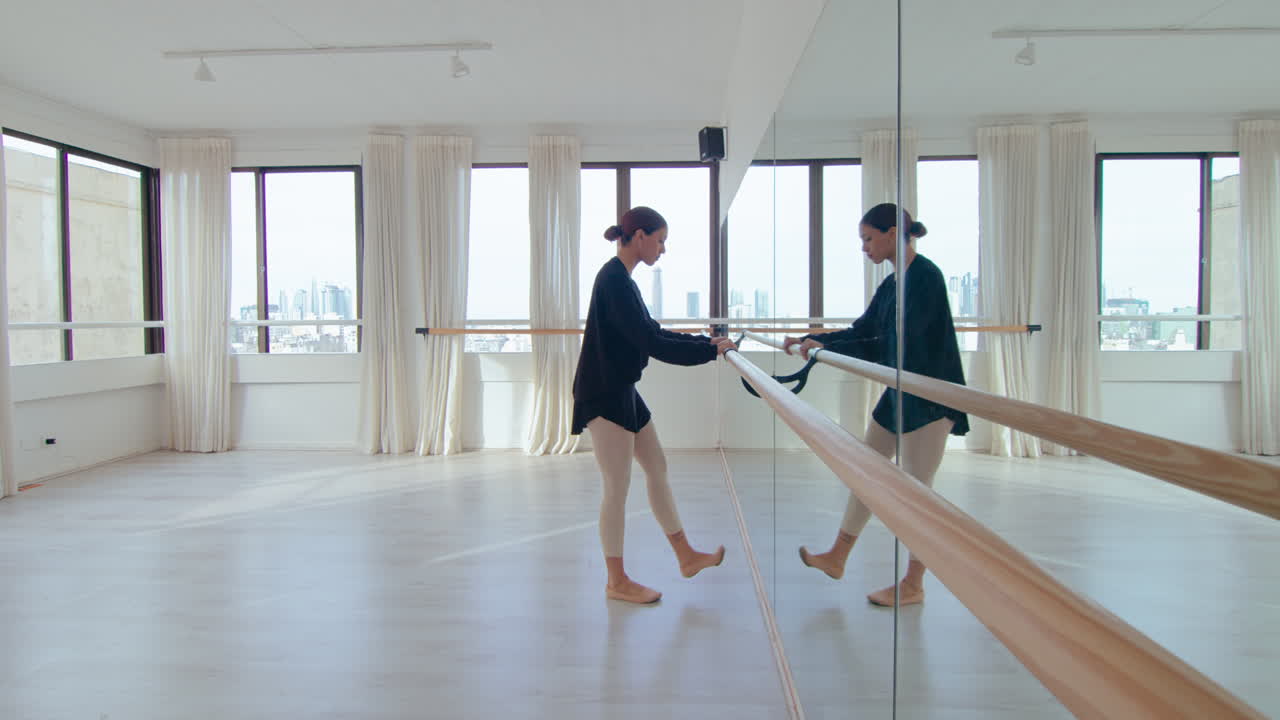 Girl Doing Warmup at the Barre before Ballet Class